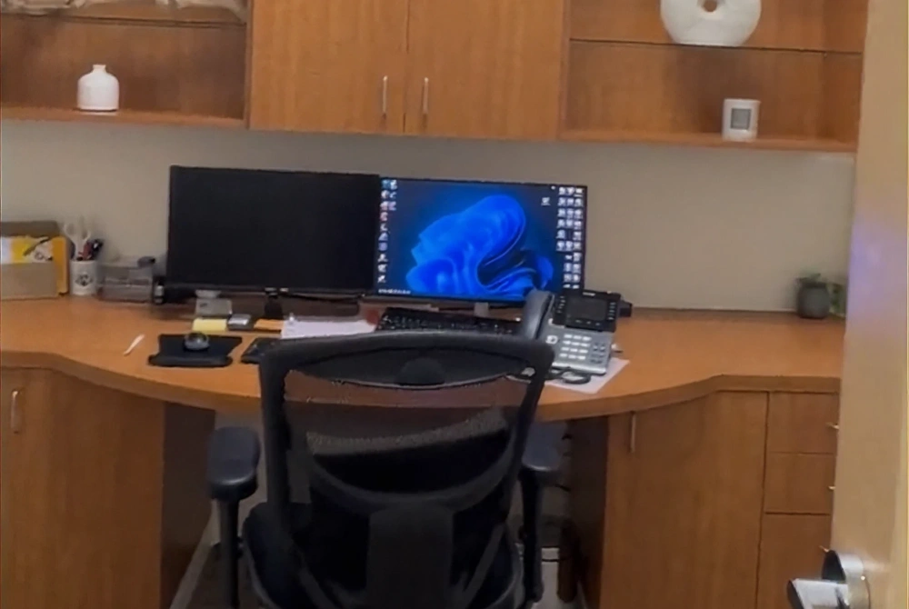 Dental office consultation workstation with computer setup and modern clinical workspace